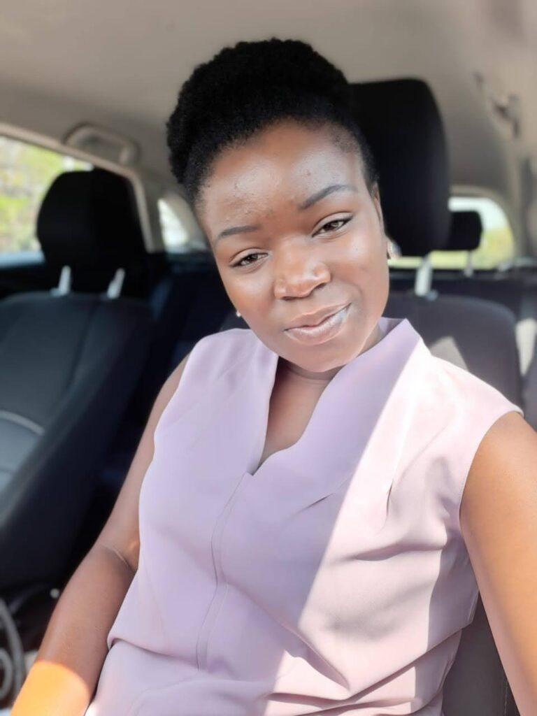 An african women with an afro bun sitting in a car